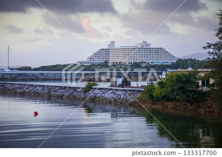 July 25, 2025, Okinawa, Japan, Cape Manzamo: The tranquil port of Onna Village in Okinawa and the distant resort hotels. 133317700