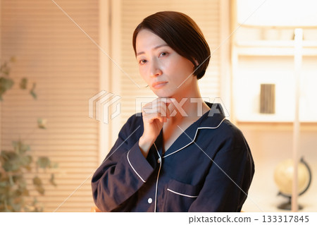 A woman in pajamas who is worried A woman in pajamas who is worried 133317845