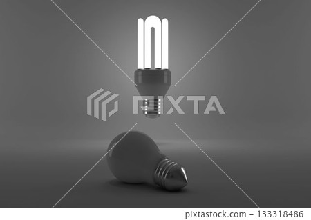 Lit energy efficient lightbulb over bulb 133318486