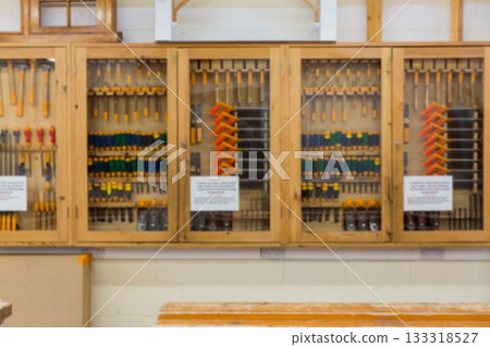 Flat design glass-front cabinets are displaying woodworking tools, instruction signs in workshop Flat design glass-front cabinets are displaying woodworking tools, instruction signs in workshop 133318527