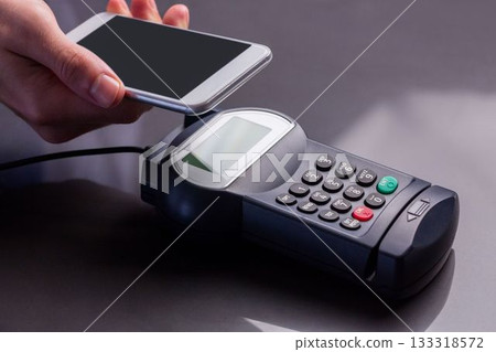 Man using smartphone to express pay Man using smartphone to express pay 133318572