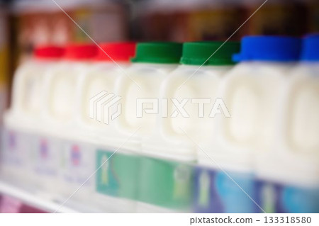 Milk bottles for sale on shelf at supermarket Milk bottles for sale on shelf at supermarket 133318580