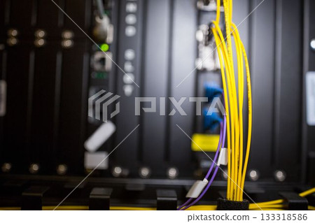 Yellow fiber optic cables are showing in vector network rack illustration, featuring purple cables 133318586