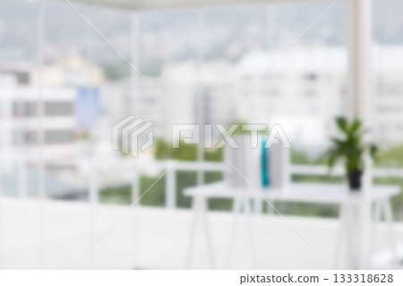 Defocused image of table against glass window 133318628