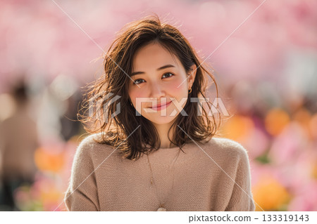 Portrait of a smiling woman surrounded by spring flowers 133319143