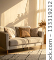 Sofa and cushions in the living room bathed in morning sunlight 133319212