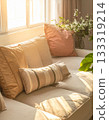 Sofa and cushions in the living room bathed in morning sunlight 133319214
