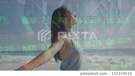 Woman in tank top stretching arms on sandy beach beneath pier, with stock tickers and waves Woman in tank top stretching arms on sandy beach beneath pier, with stock tickers and waves 133319518