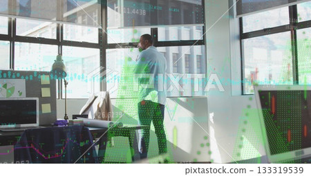 Talking businessman holding smartphone while gazing outside in modern office with chart overlays Talking businessman holding smartphone while gazing outside in modern office with chart overlays 133319539