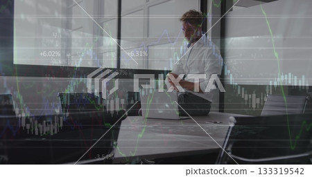 Sitting executive wearing loose tie holding smartphone above laptop at conference table, copy space 133319542