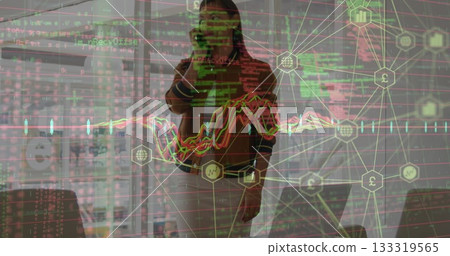 Talking businesswoman wearing blazer standing in office space, smartphone laptop financial overlays 133319565