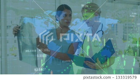 Examining doctors reviewing chart and X-ray film in exam room, with stethoscope, digital interface 133319579