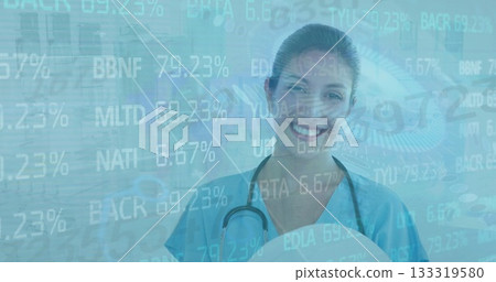 Smiling clinician in scrubs viewing data overlay in clinic, with stethoscope and digital eye Smiling clinician in scrubs viewing data overlay in clinic, with stethoscope and digital eye 133319580