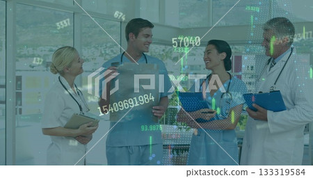 Medical team in uniforms examining X-ray film in hospital corridor, with clipboards, stethoscopes Medical team in uniforms examining X-ray film in hospital corridor, with clipboards, stethoscopes 133319584