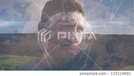 Showing adult man gazing over rural hills with holographic globe and floating data graphics Showing adult man gazing over rural hills with holographic globe and floating data graphics 133319602