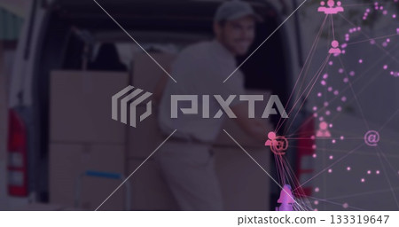 Unloading uniformed delivery worker lifting cardboard box at van rear, with digital network overlay 133319647