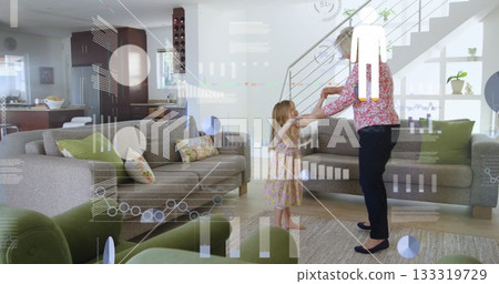 Dancing grandmother with granddaughter twirling in open plan living room, with gray sofas Dancing grandmother with granddaughter twirling in open plan living room, with gray sofas 133319729
