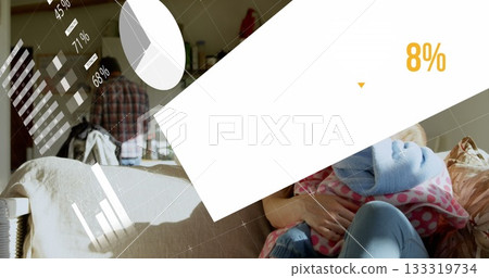 Woman wearing jeans holding infant at home on beige couch with polka-dot blanket and data overlay Woman wearing jeans holding infant at home on beige couch with polka-dot blanket and data overlay 133319734
