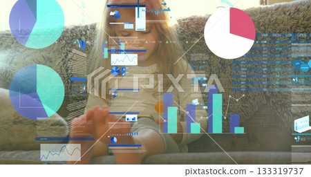 Sitting girl studying data on tablet atop fuzzy throw blanket on sofa, with projected chart visuals Sitting girl studying data on tablet atop fuzzy throw blanket on sofa, with projected chart visuals 133319737