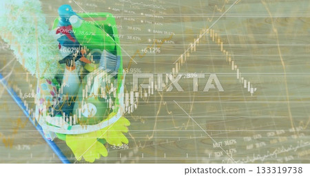 Displaying frog-shaped plush backpack resting on wooden floor with stock charts overlay, copy space 133319738