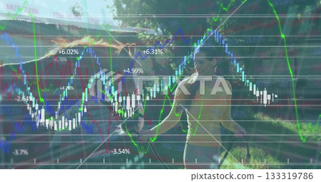 Jumping woman holding jump rope handles backyard bright sunlight, with financial charts, copy space Jumping woman holding jump rope handles backyard bright sunlight, with financial charts, copy space 133319786
