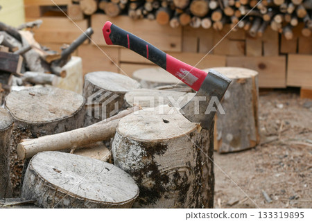 Axe stuck in a wood chopping block Axe stuck in a wood chopping block 133319895