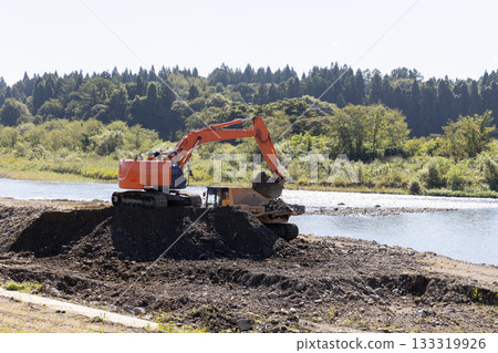 Heavy machinery used to widen the river channel 133319926