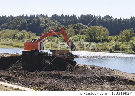 Heavy machinery used to widen the river channel Heavy machinery used to widen the river channel 133319927