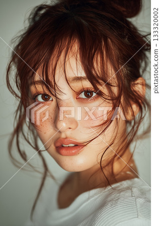 一位微笑的年輕女子在藍色背景前的肖像（自然美、潔淨、自然） 133320002