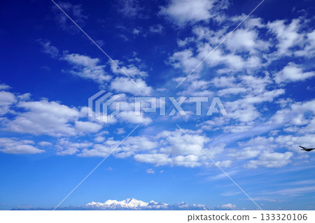 Deep Blue Sky with Cumulus Clouds Over the Distant Snow Capped Himalayan Peaks Deep Blue Sky with Cumulus Clouds Over the Distant Snow Capped Himalayan Peaks 133320106