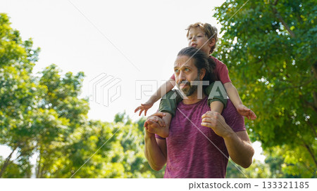Happy Family. Happy little boy stretching out hands while his father carrying Happy Family. Happy little boy stretching out hands while his father carrying 133321185