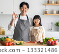 Parent and child cooking! Daughter helping her father cook with an OK sign 133321486