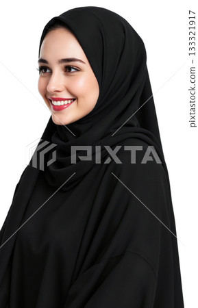 Woman Hijab Smiling. A young woman wearing a black hijab and abaya smiles warmly while looking off to her right 133321917
