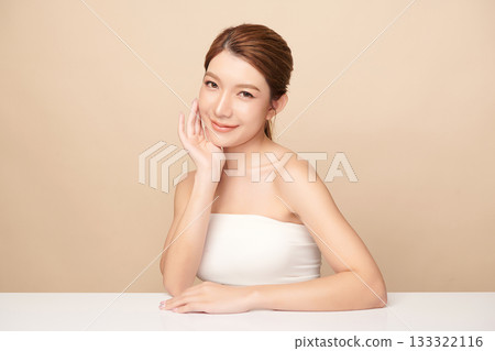 A beautiful young Asian woman with clean, fresh skin against a beige background. Skincare, facial treatment, cosmetology, beauty, and spa. An elegant portrait of an Asian woman. A beautiful young Asian woman with clean, fresh skin against a beige background. Skincare, facial treatment, cosmetology, beauty, and spa. An elegant portrait of an Asian woman. 133322116