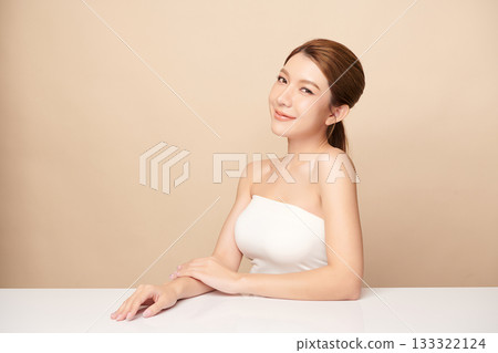 A beautiful young Asian woman with clean, fresh skin against a beige background. Skincare, facial treatment, cosmetology, beauty, and spa. An elegant portrait of an Asian woman. A beautiful young Asian woman with clean, fresh skin against a beige background. Skincare, facial treatment, cosmetology, beauty, and spa. An elegant portrait of an Asian woman. 133322124