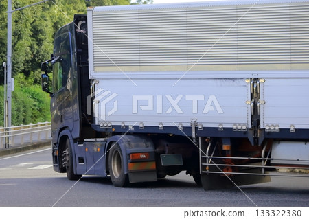 A trailer truck turning right at an intersection A trailer truck turning right at an intersection 133322380