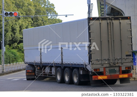 A trailer truck turning right at an intersection A trailer truck turning right at an intersection 133322381