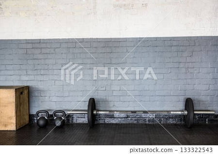 Loaded barbell is being shown in flat design gym corner, featuring kettlebells and wooden plyo box Loaded barbell is being shown in flat design gym corner, featuring kettlebells and wooden plyo box 133322543