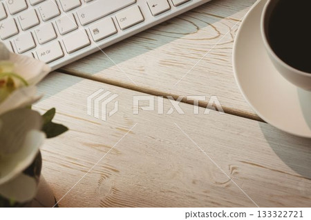 Keyboard and coffee cup on table 133322721