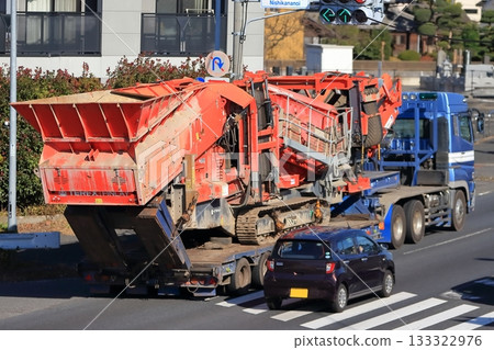 Trailer transporting heavy machinery 133322976