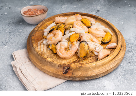 Frozen Raw Seafood Cocktail with Mussels, Clams, Prawns, Shrimps and squid. grey background. top view 133323562