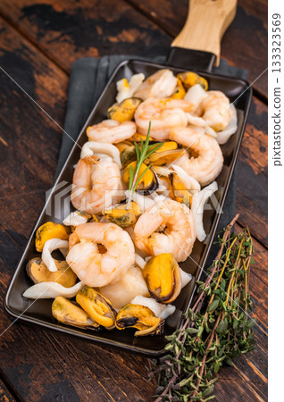 Seafood Cocktail appetiser with Mussels, Clams, Prawns, Shrimps and squid. wooden background. top view Seafood Cocktail appetiser with Mussels, Clams, Prawns, Shrimps and squid. wooden background. top view 133323569