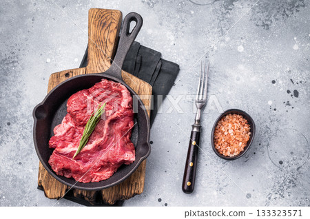 Ready for grilling Raw hanging tender or Hanger beef steak in a pan. grey background. top view Ready for grilling Raw hanging tender or Hanger beef steak in a pan. grey background. top view 133323571