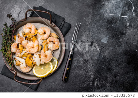 Fresh Seafood Mix with Mussels, Clams, Prawns, Shrimps and squid. black background. top view 133323578