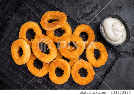 Ready or eat Deep Fried crunchy onion rings, delicious snack. black background. top view Ready or eat Deep Fried crunchy onion rings, delicious snack. black background. top view 133323585