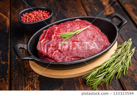 Ready for cooking beef cheeks, raw meat in skillet. wooden background. top view Ready for cooking beef cheeks, raw meat in skillet. wooden background. top view 133323594