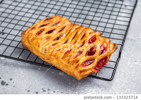 Danish pastry with a strawberry and cream cheese filling. grey background. top view Danish pastry with a strawberry and cream cheese filling. grey background. top view 133323714