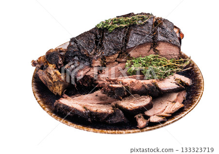 Baked and sliced Venison leg. roast meat of deer with bone on a plate isolated on white background. top view 133323719