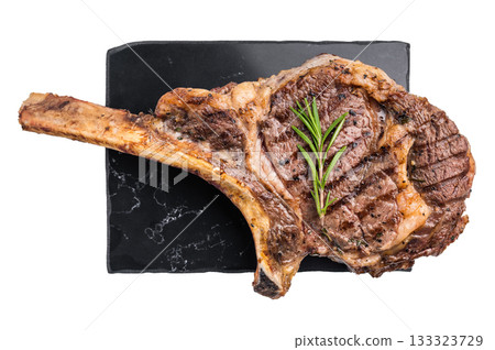 BBQ Grilled Tomahawk beef steak, cooked rib eye with bone on marble board isolated on white background. top view BBQ Grilled Tomahawk beef steak, cooked rib eye with bone on marble board isolated on white background. top view 133323729