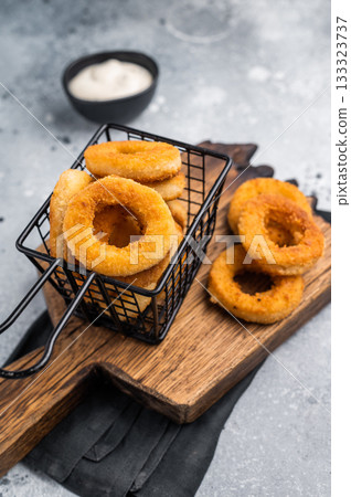 Deep Fried crunchy onion rings, delicious snack. grey background. top view 133323737